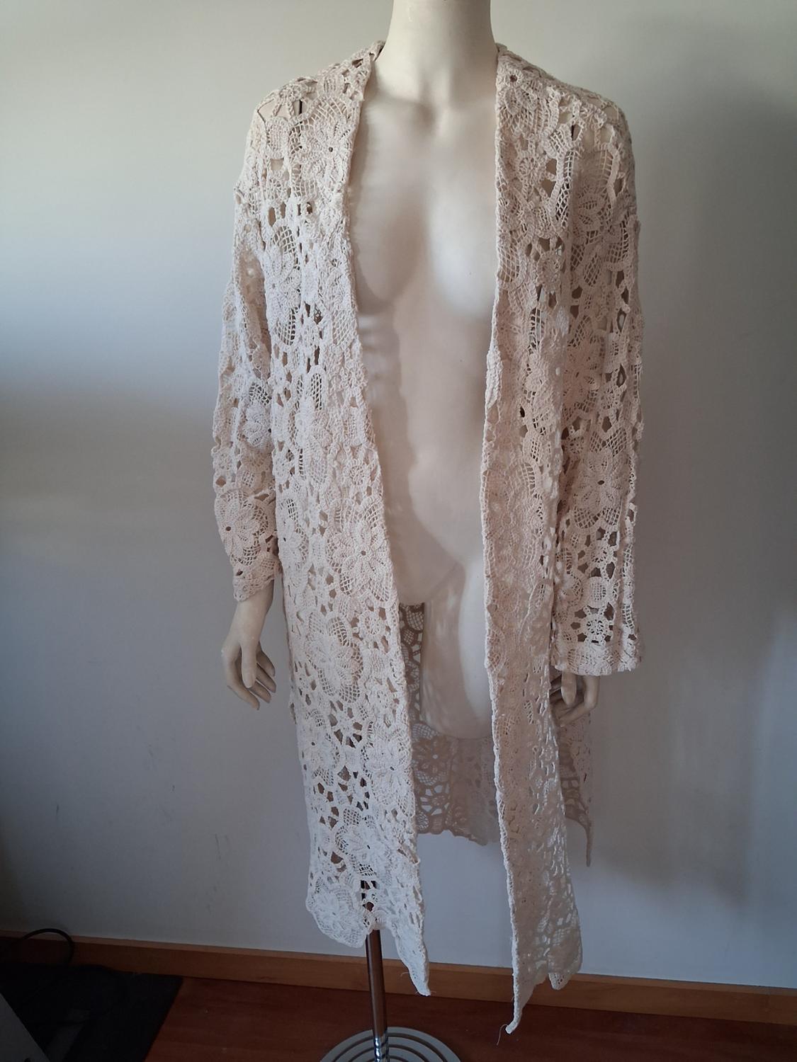 Mannequin in a beige lace robe, floral design, long sleeves, in a minimalist setting with a white background.