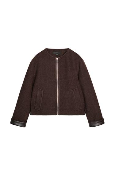 Front view of a brown bomber jacket with a round neck, long sleeves with turn-ups, front pockets, and a zip fastening.
