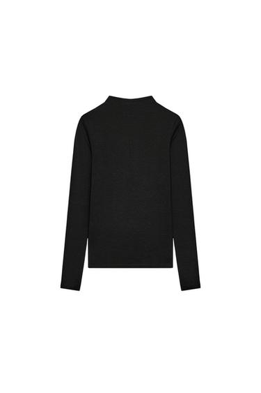 Rear view of black long-sleeved turtleneck T-shirt.