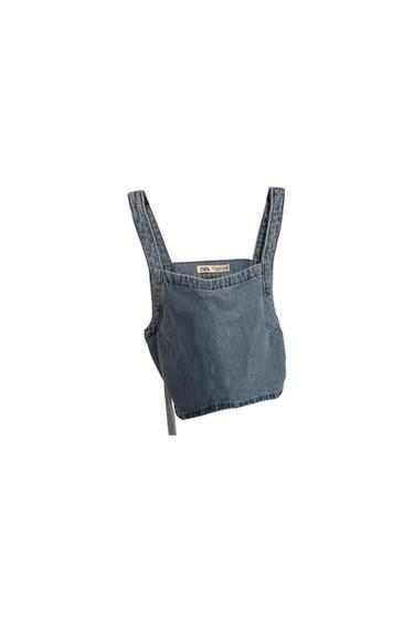 Front view of a blue denim crop top with wide straps.