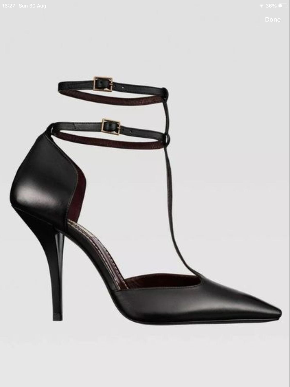 Black pointed-toe heeled shoe with a T-strap and double buckle fastening on a grey background. Text: 16:27 Sun 30 Aug 36% Done.