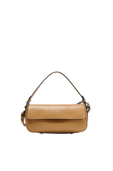 Camel-coloured shoulder bag with flap and short handle with dark buckles, on a white background.