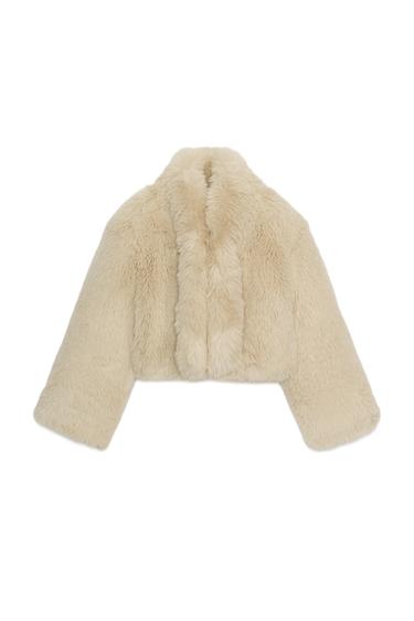 Rear view of a short beige faux fur coat with a lapel collar and long sleeves.