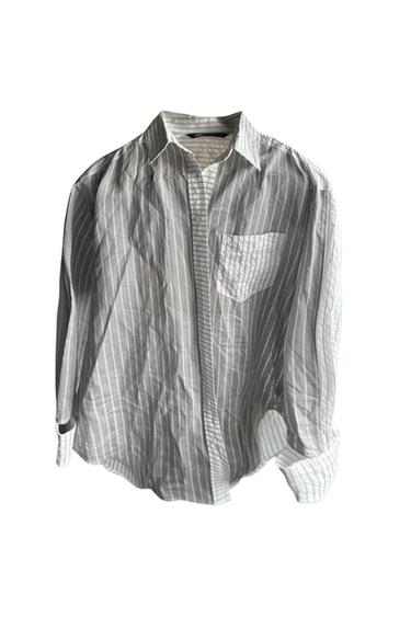 Front view of gray striped shirt with front pocket.