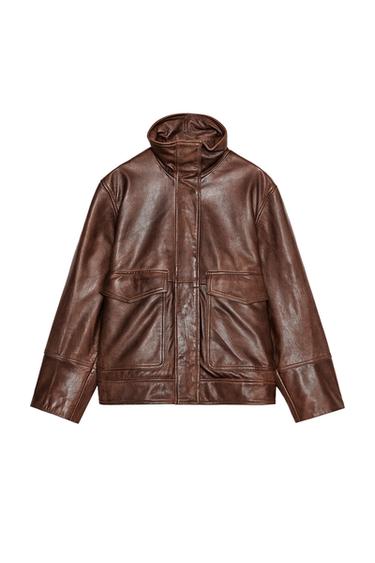 Front view of a brown jacket with front flap pockets and a stand-up collar.