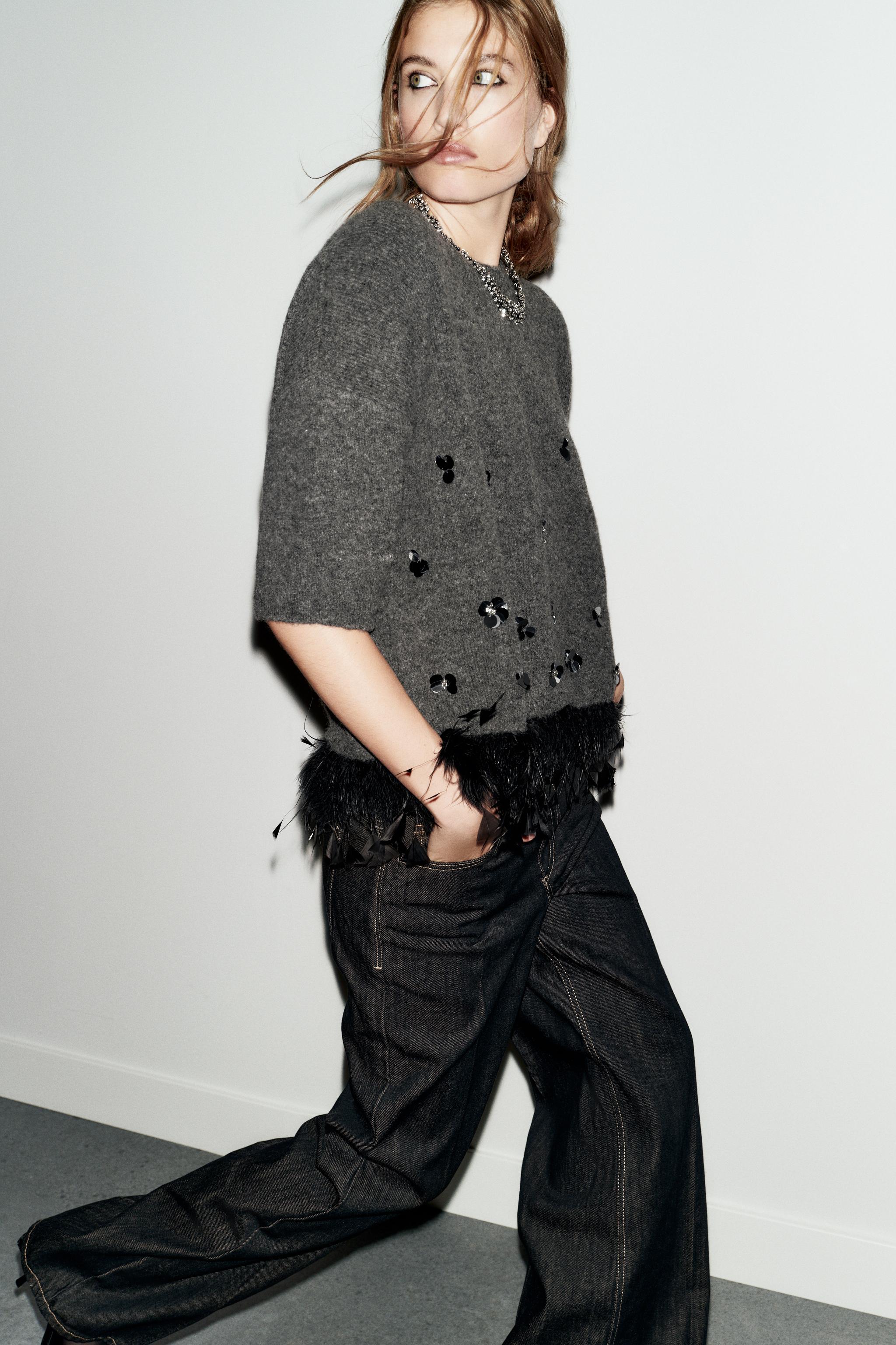 WOOL SWEATER WITH SEQUINS AND FEATHERS