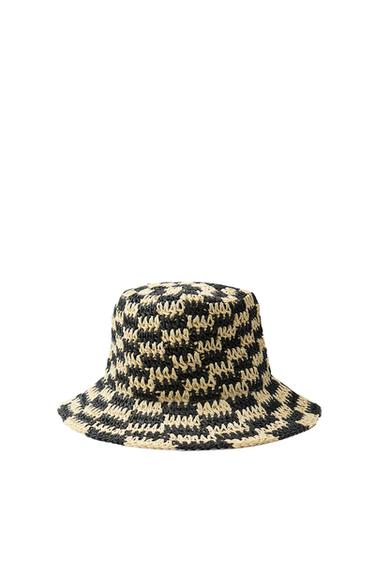 Front view of a wide-brimmed hat with a black and beige woven design.