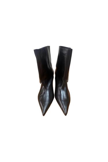 Front view of pointed black ankle boots with a mid-height heel.