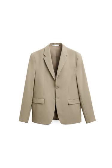 Front view of a beige jacket with lapels and flap pockets.