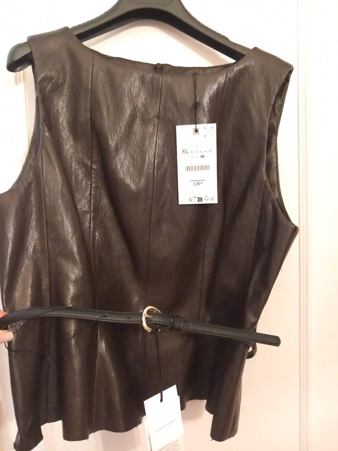 Dark brown sleeveless top and belt on a hanger. Visible text: XL, XL 32 XL XL EG, € 29, zara.com contact.