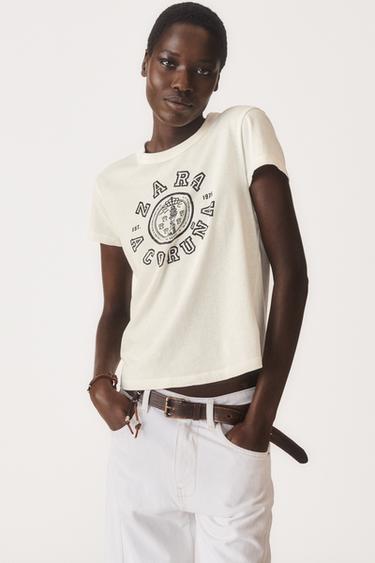 تيشرت VARSITY 50TH ANNIVERSARY - أبيض مكسور الخاص بـ Zara
