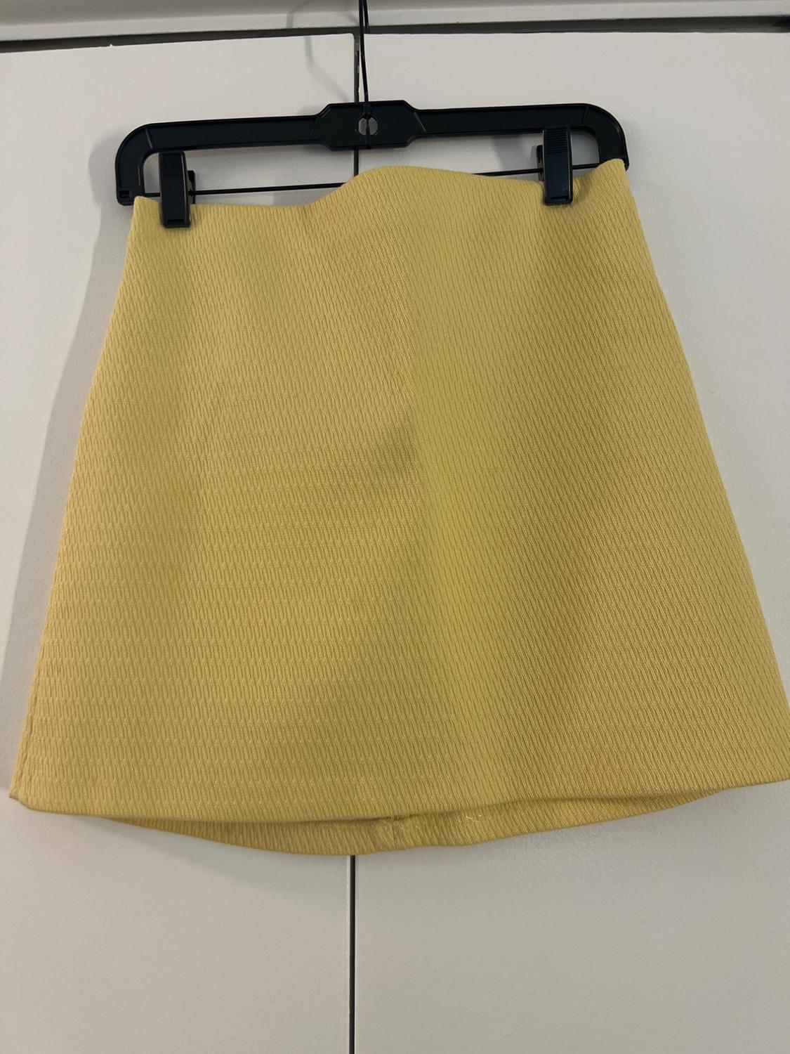 Front view of yellow skirt with hook texture.