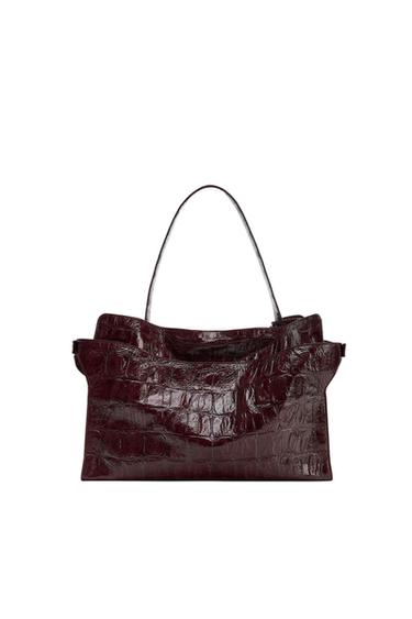 Burgundy handbag with a glossy finish, crocodile texture and a top handle, against a white background.