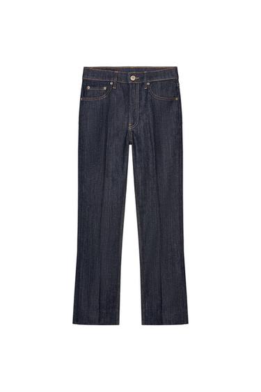Front view of blue flared trousers, mid-rise, with front and back pockets, visible seams and button fastening.