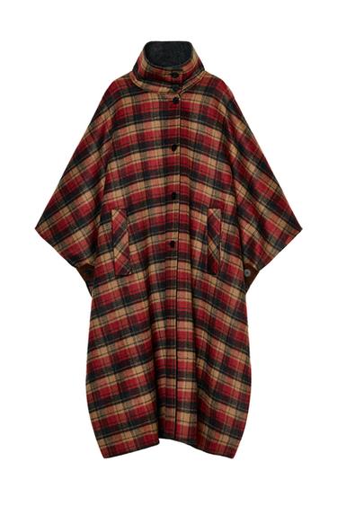Front view of a burgundy and ecru checked cape, high neck, front pockets, front button fastening, asymmetrical hem.