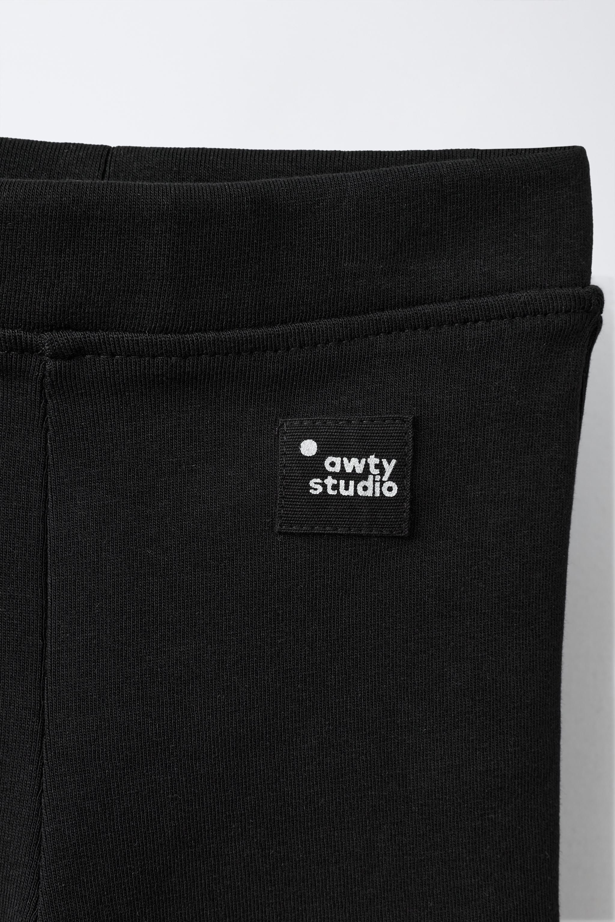 LABEL DETAIL INTERLOCK FLARE LEGGINGS