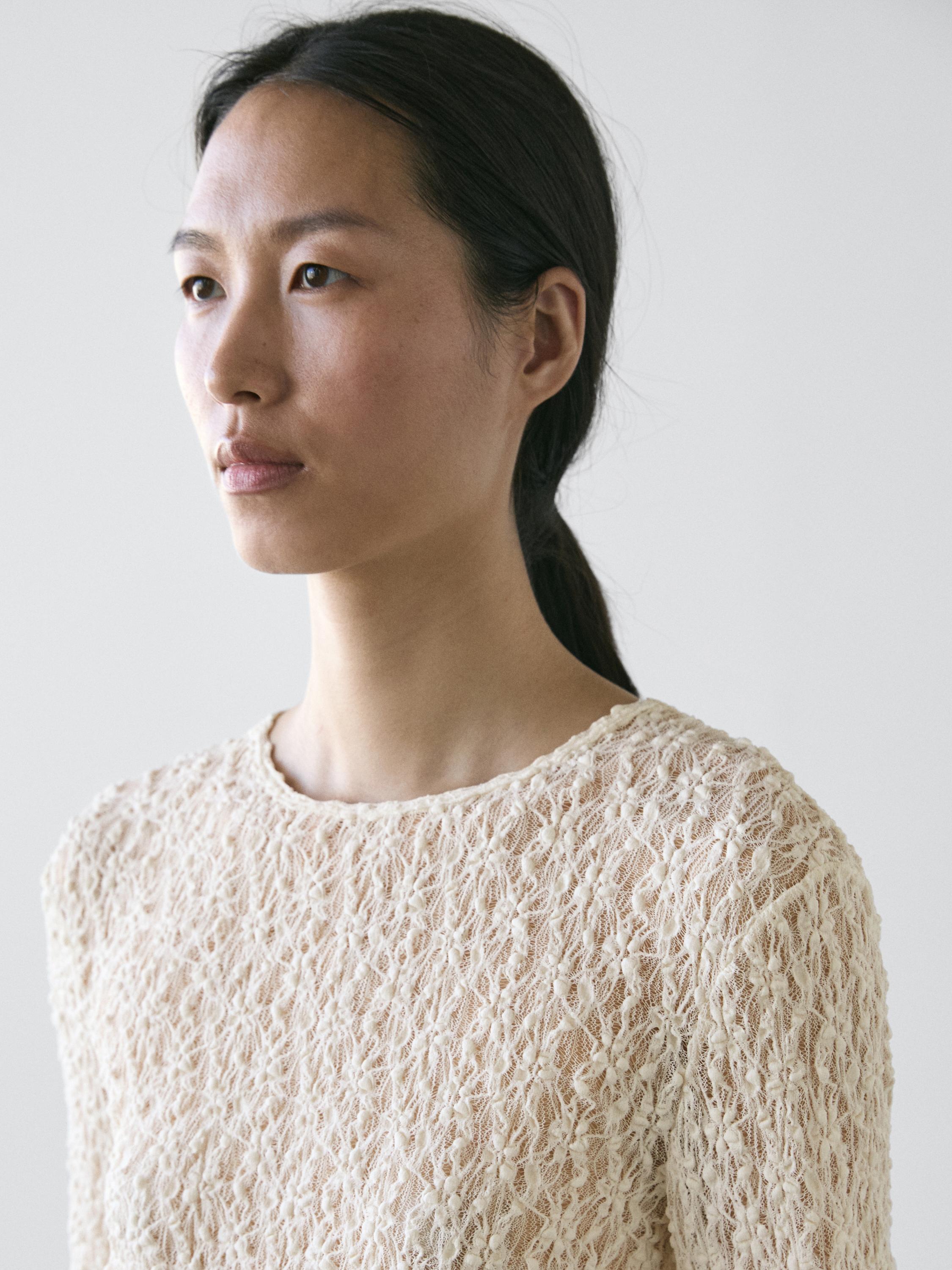 Openwork knit top with long sleeves and lace