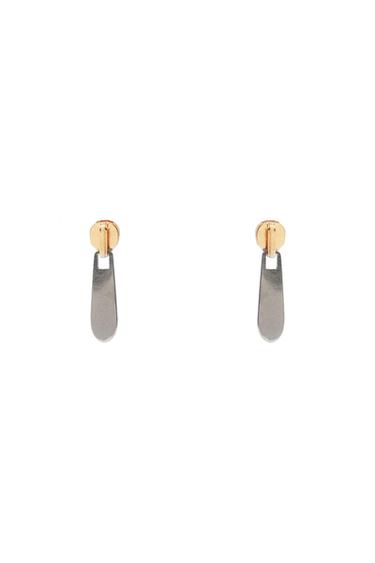 Pair of zip-pull-shaped earrings. They have a gold-coloured top and a silver-coloured pendant, on a white background.