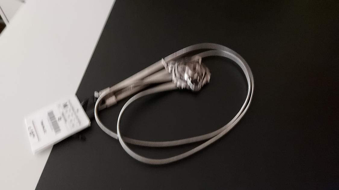 Blurred image of a metallic object with a visible label.