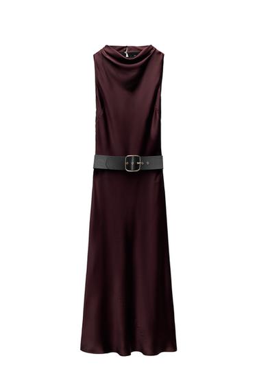 Front view of sleeveless burgundy dress with black belt and gold buckle.