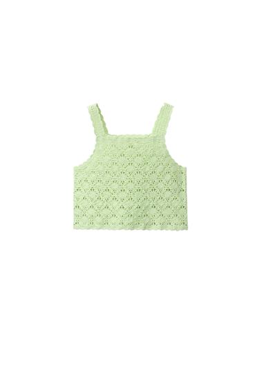Front view of a light green tank top with a cutout design.