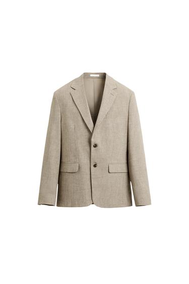 Front view of a beige blazer with peak lapels and two buttons.
