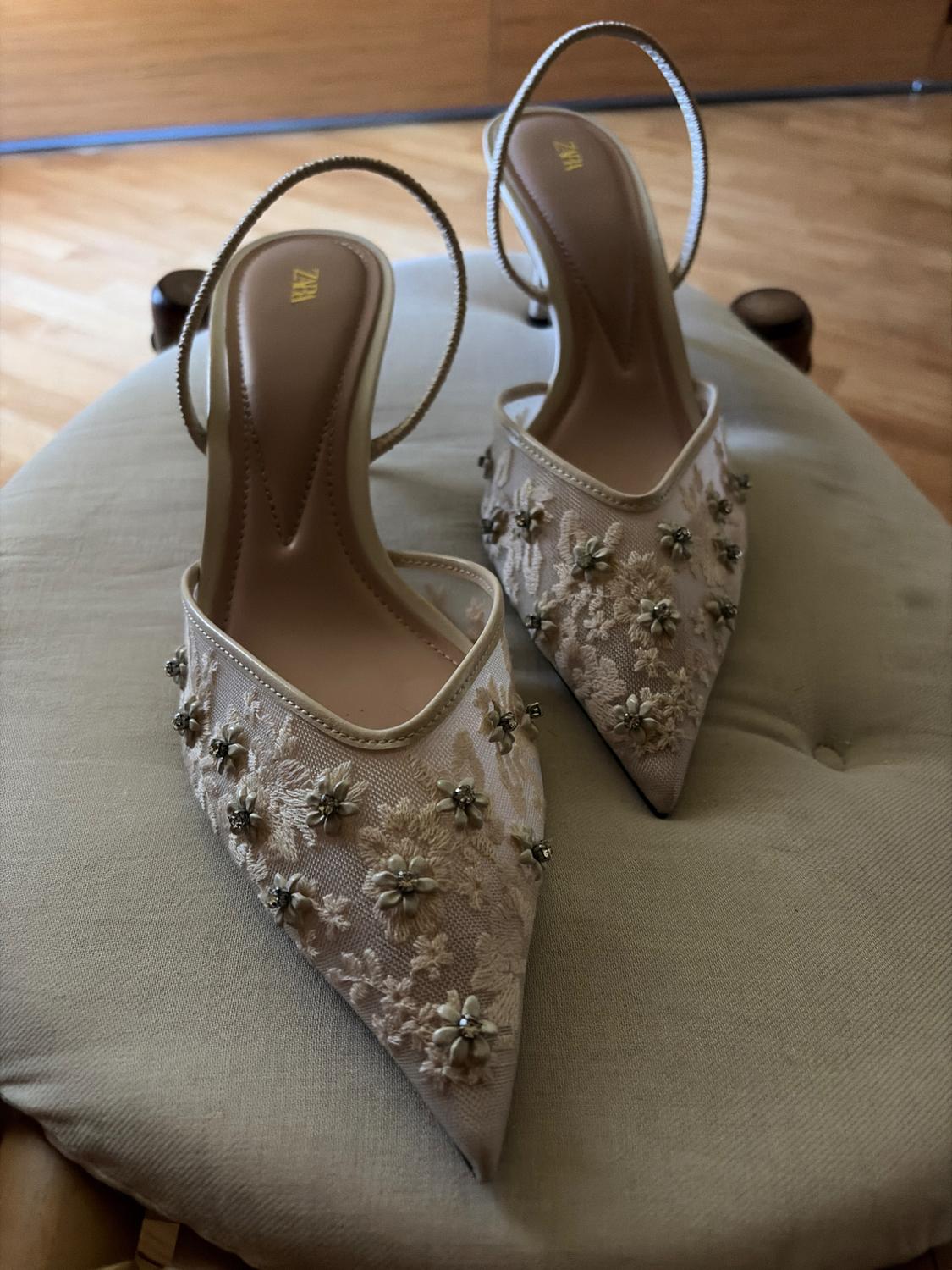 Beige slingback heels with floral embroidery and appliqués on a cushioned sole. The insole reads ZARA.