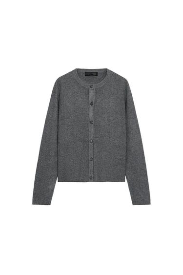 Front view of a grey knitted jacket with a round neck, long sleeves, and a front button fastening.