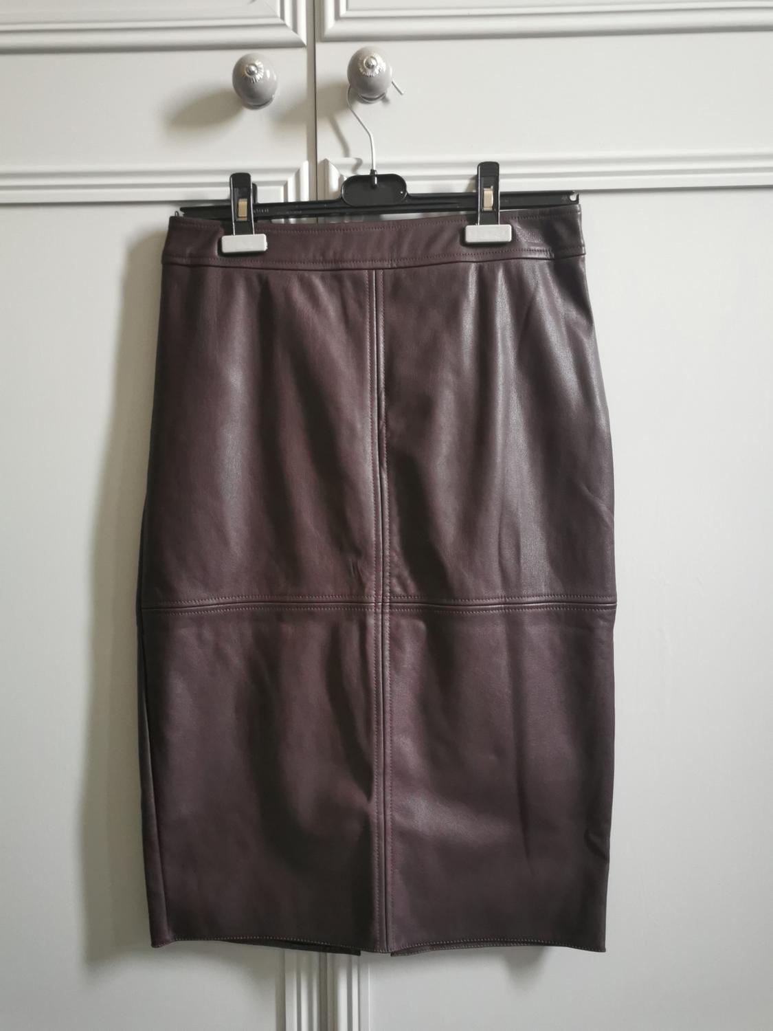 Front view of a brown pencil skirt with visible seams.