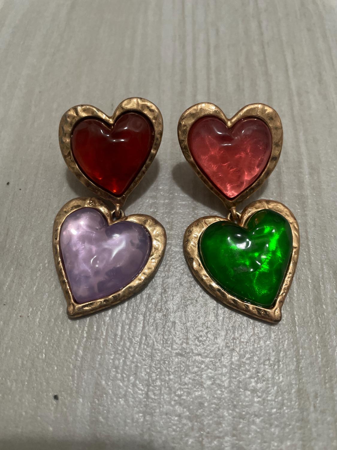 Double heart earrings with gold edges. The top hearts are red and pink, the bottom ones are lilac and green.