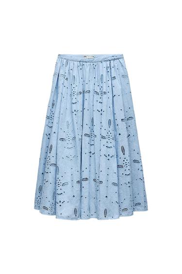 Light blue midi skirt with perforated embroidery and a flared hem on a white background. ZARA text on the label.