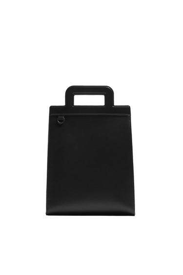 Front view of a black handbag with a rectangular top handle.