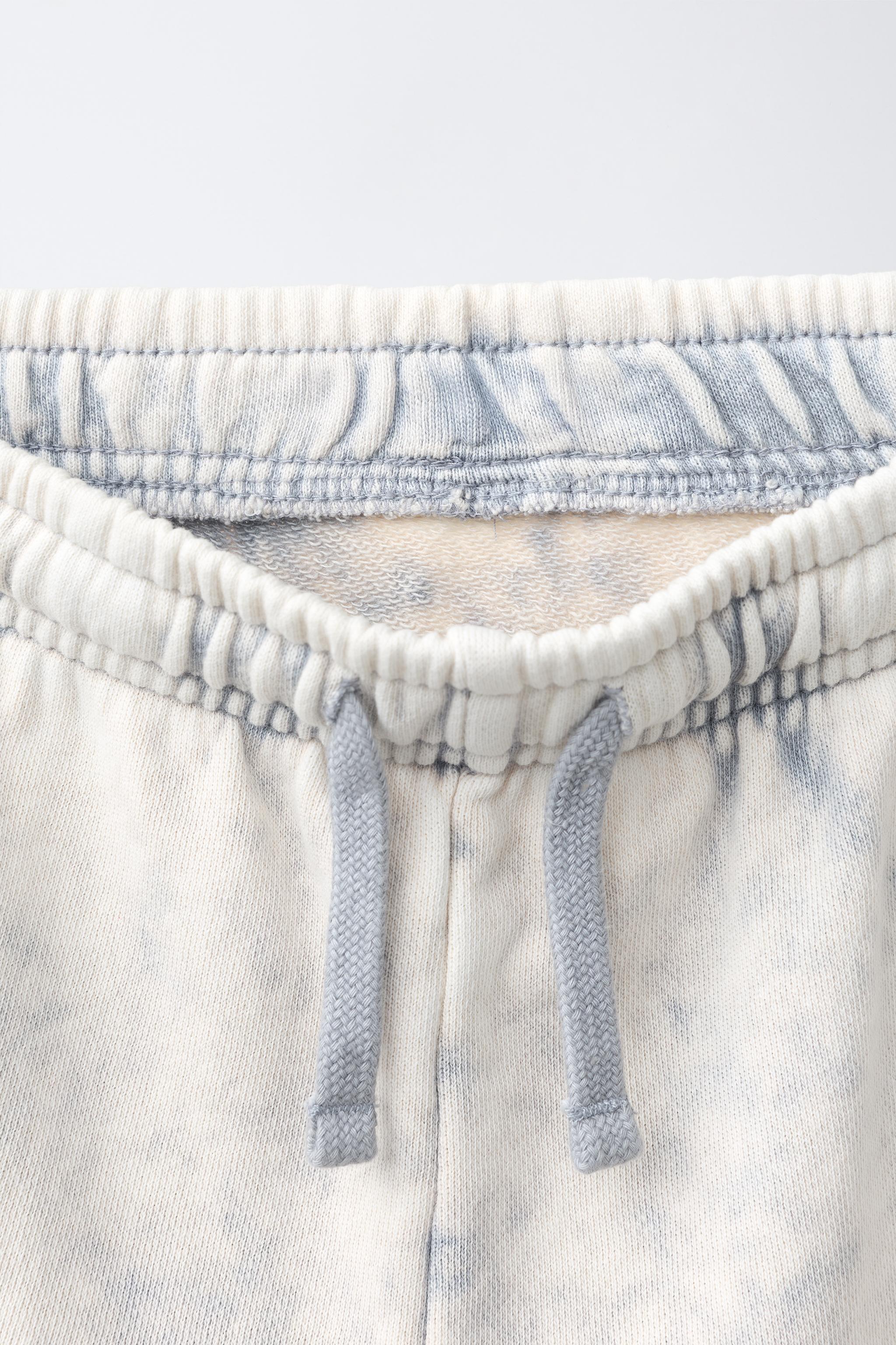 WASHED EFFECT STAR PATCH LONG BERMUDA SHORTS
