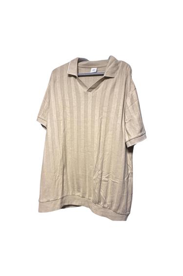 Front view of a beige shirt with vertical stripes and a classic collar.
