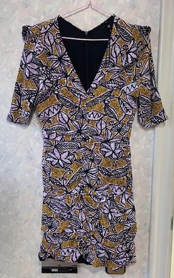 Floral print swing dress in purple, black, and mustard tones, with a V-neckline and three-quarter length sleeves.
