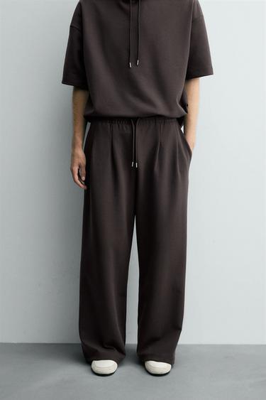 NEOPRENE-EFFECT PLEATED TROUSERS WITH LABEL - Dark brown by Zara