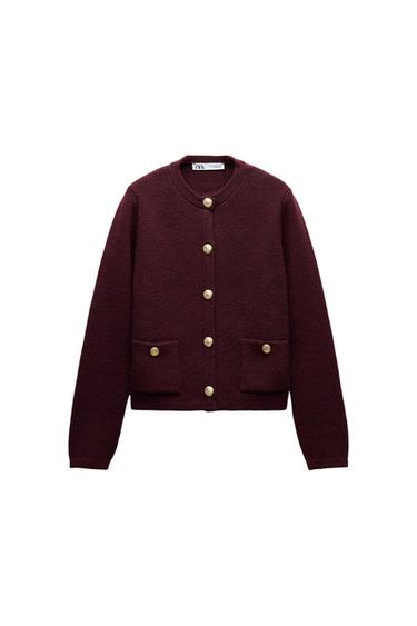 Front view of a burgundy jacket with gold buttons and front pockets.