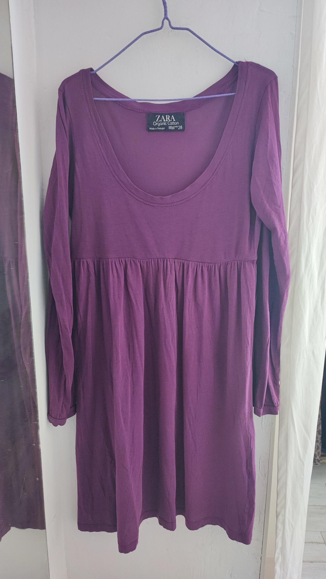 Purple long-sleeved dress hanging on a hanger. Visible tag: "ZARA Organic Cotton, Made in Turkey, EUR M/28".