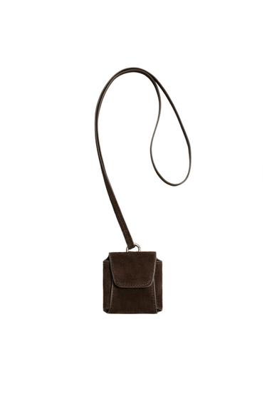 Front view of a brown earphone holder with a pendant and a metal ring. Square design with a flap.