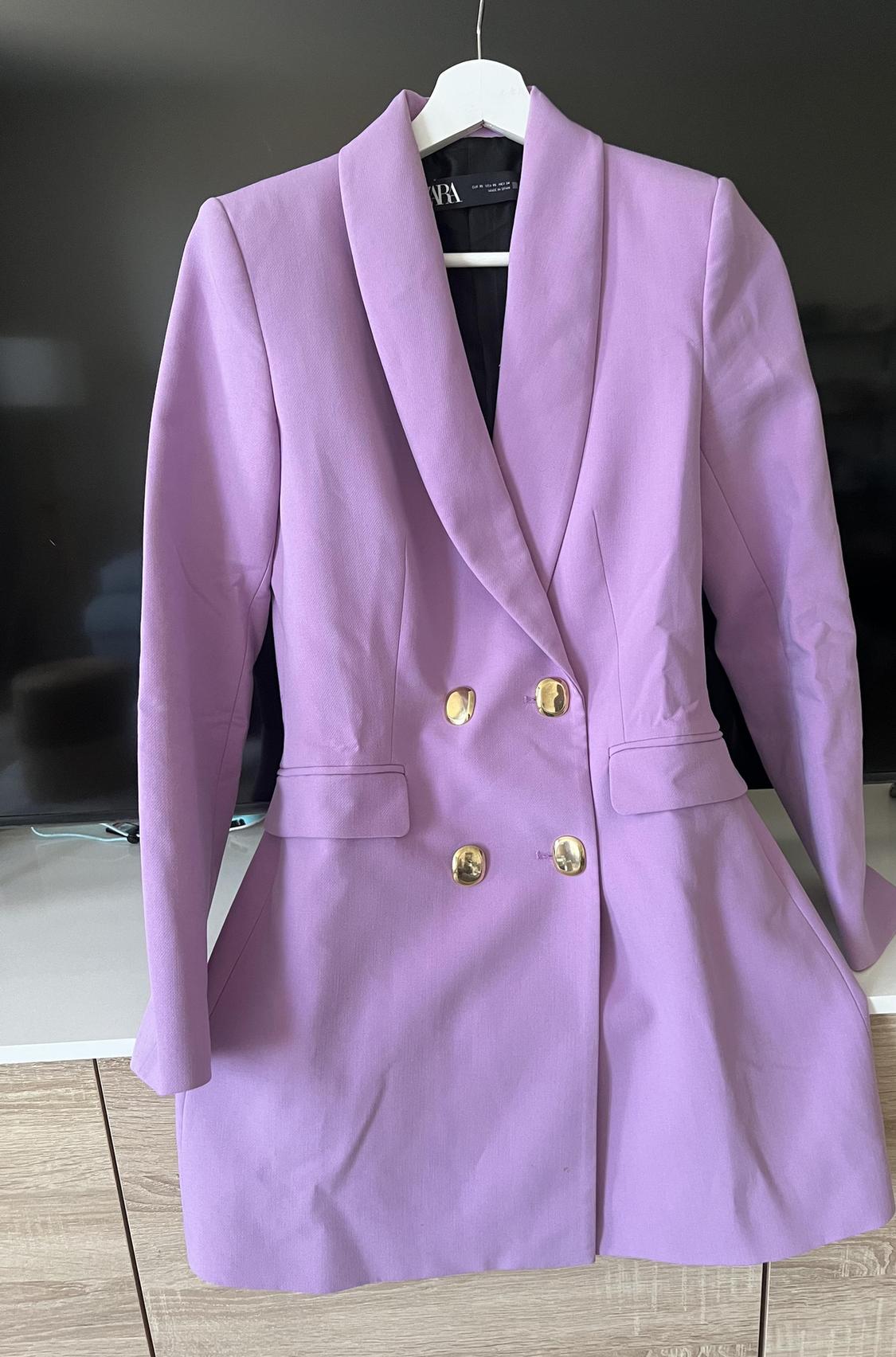 Front view of lilac blazer with gold buttons and front pockets.