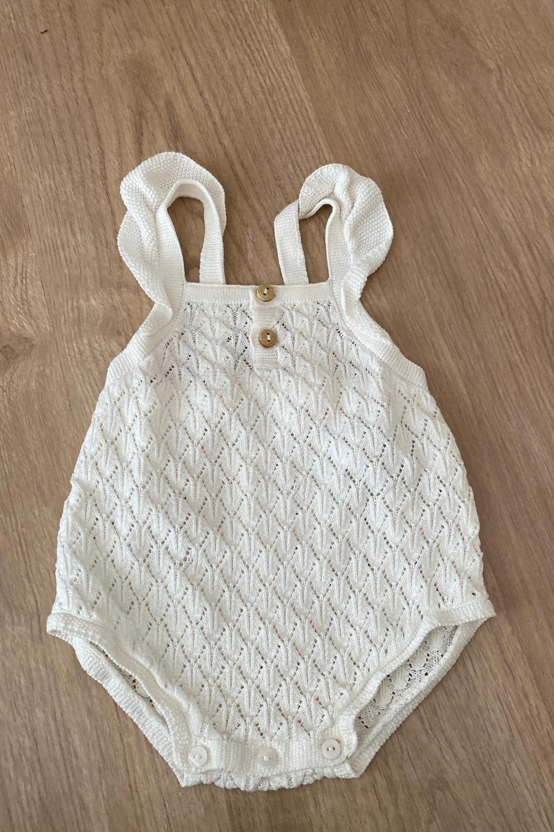 OPEN-KNIT ROMPER WITH RUFFLES