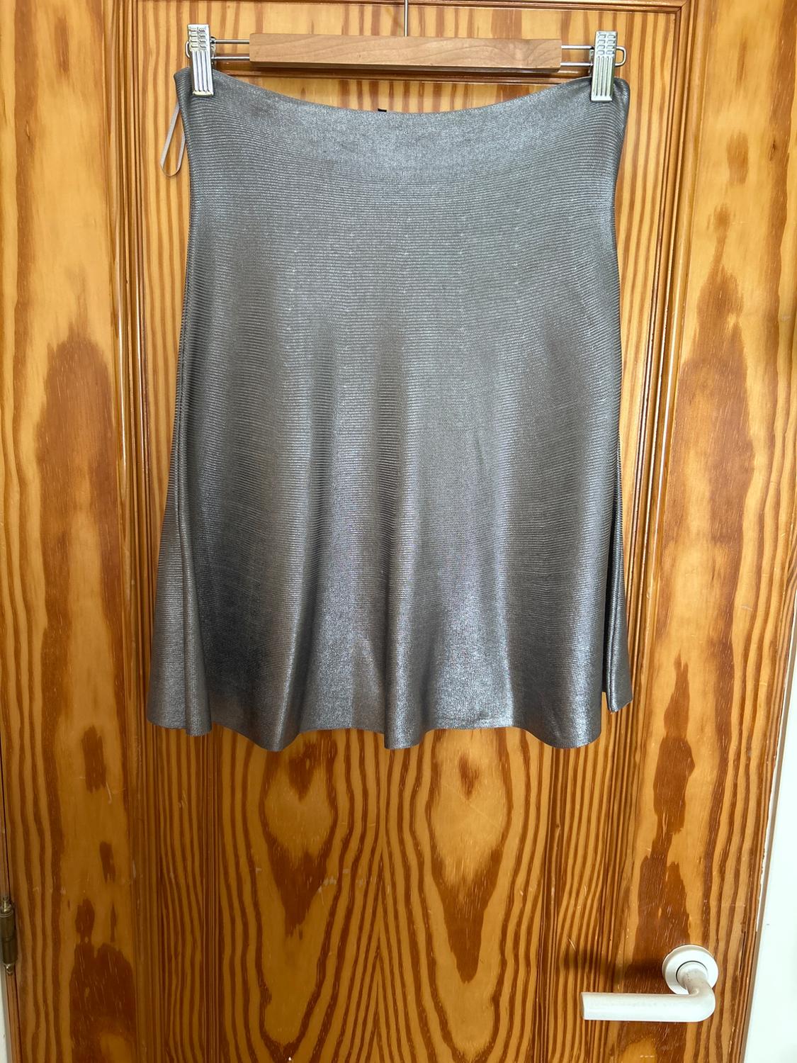Front view of a metallic grey skirt with a fluid cut.
