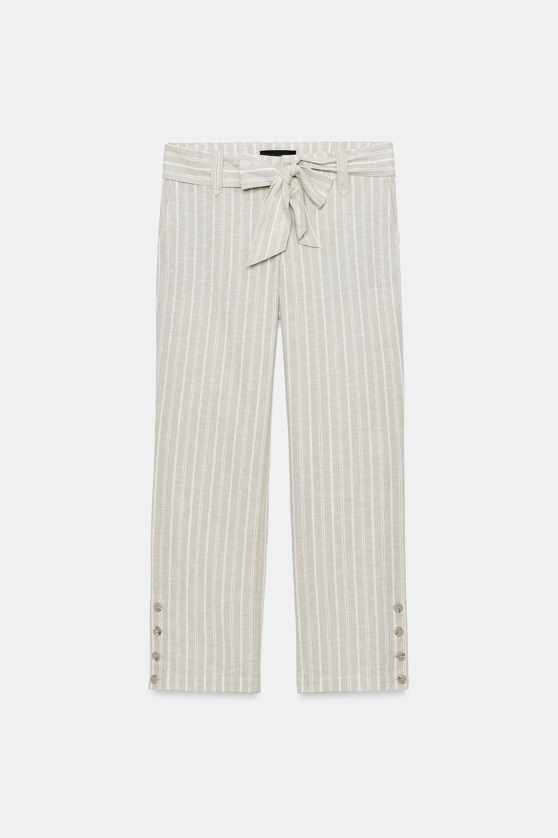 Front view of striped tan trousers with a knotted belt and buttons at the cuffs.