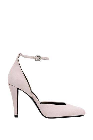 Side view of pink high-heeled shoe with adjustable ankle strap.