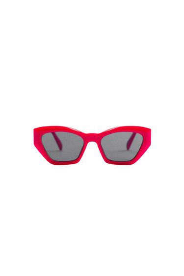 Angular designer sunglasses with a thick fuchsia pink frame and dark tinted lenses on a white background.