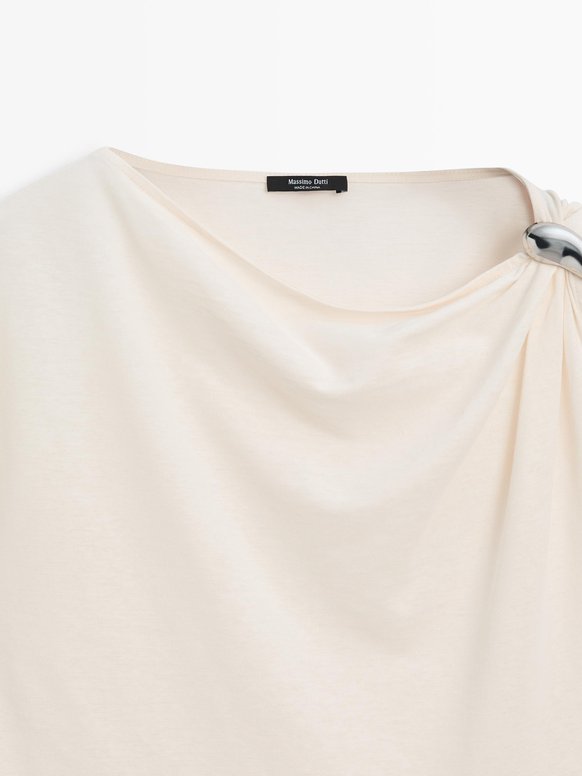 Asymmetric top with shoulder appliqué