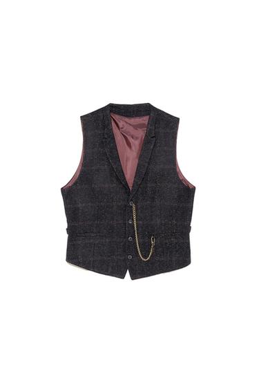 Dark waistcoat with a checked pattern, pink inner lining and decorative gold chain on the front, on a white background.