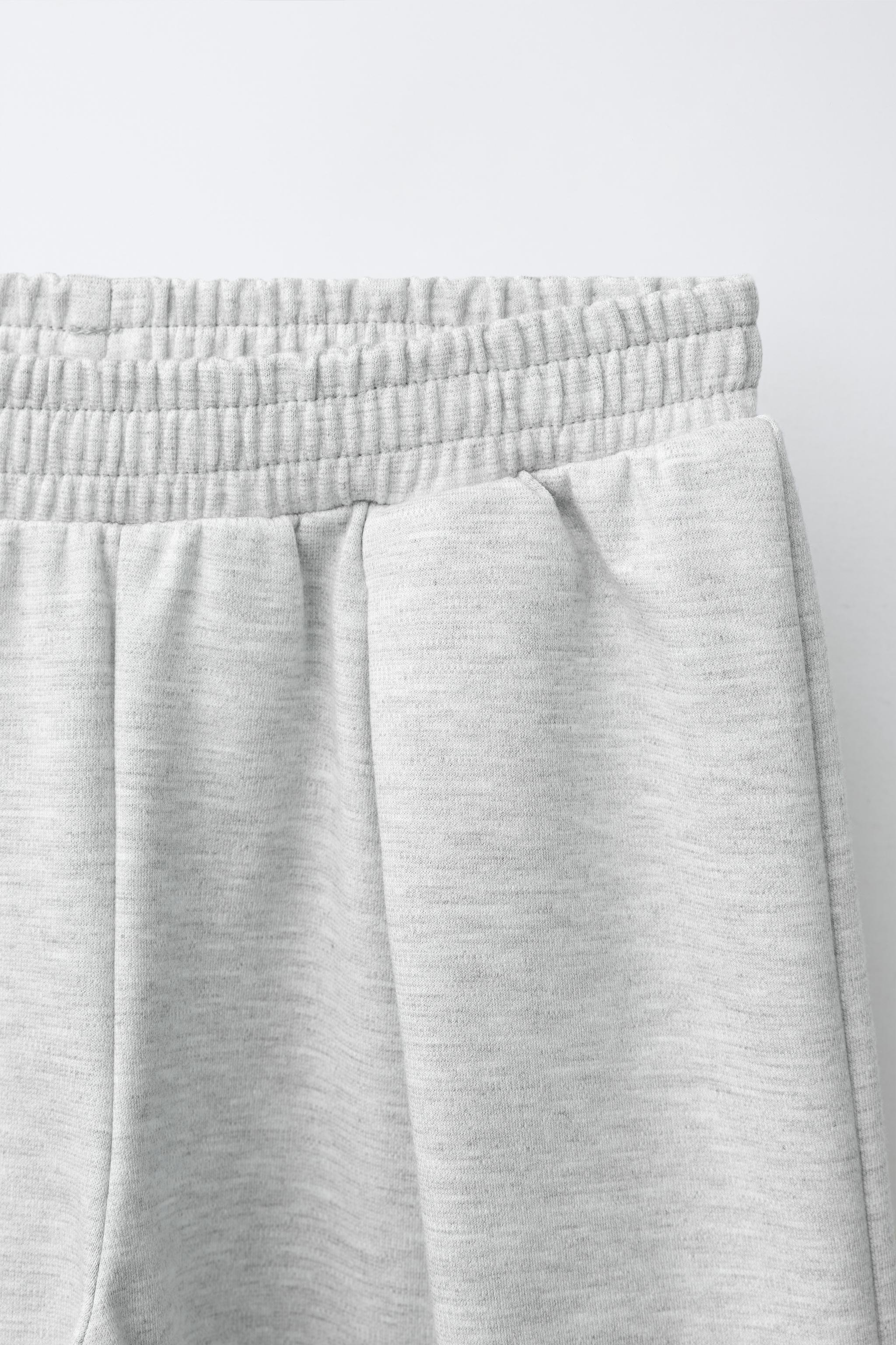 INTERLOCK PLEATED WIDE-LEG PANTS