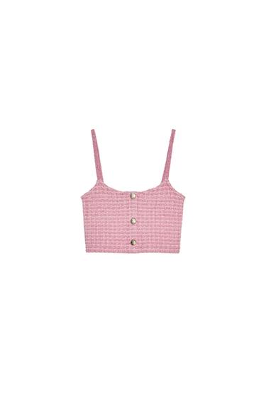 Front view of a pink top with spaghetti straps and button-down fastening.