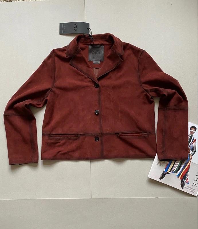 Brown three-button jacket on a light background, with a Zara label. To the right, a magazine with a fashion illustration.